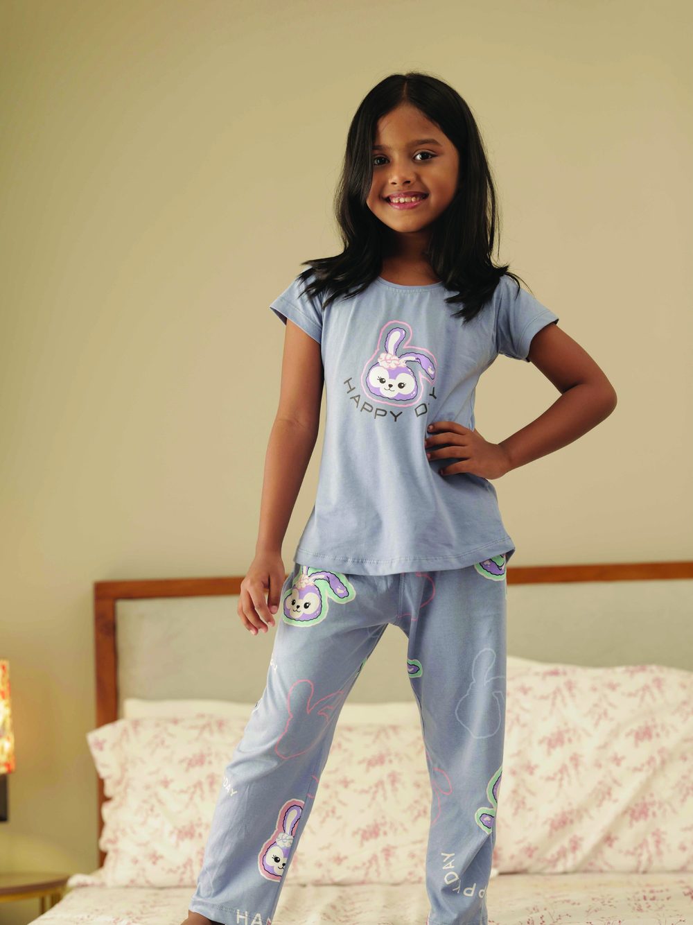 Girl wearing a blue bunny print kids nightsuit